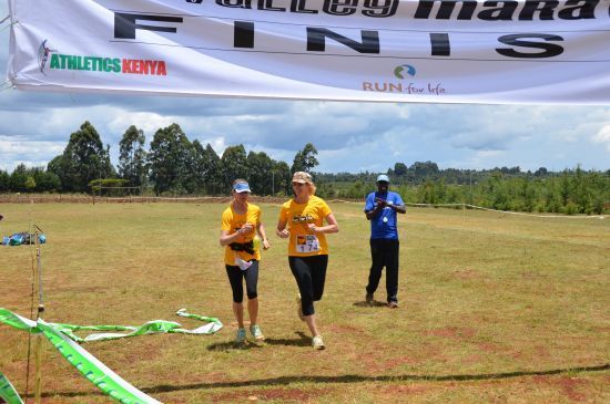 Robin crosses the finish line at the Rift Valley Marathon with a little encouragement and run-a-long by Dana
